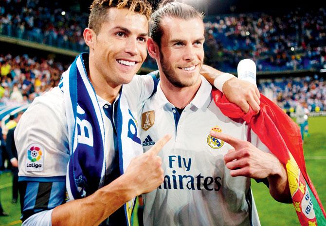 Real Madrid forwards Cristiano Ronaldo (left) and Gareth Bale celebrate after the La Liga match vs Malaga on Sunday. Pics/AFP