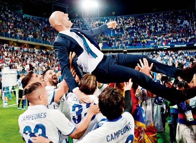 Real Madrid coach Zinedine Zidane is tossed in the air by players after the match vs Malaga on Sunday