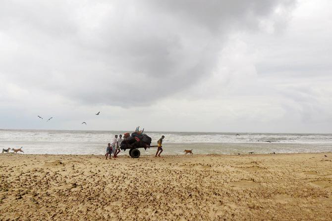 Bangladeshi villagers evacuate to cyclone shelters. Pic/AFP