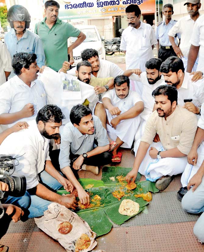 Youth Congress members during a beef festival in front of the BJP office in Ernakulam in Kochi on Saturday. Pic/PTI