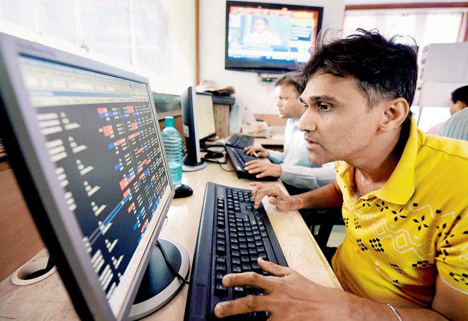 Brokers react to stock prices at the Bombay Stock Exchange as the Sensex crossesthe 31000 mark in Mumbai. Pic/PTI