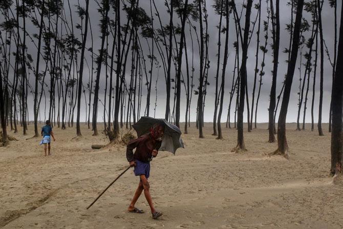 Bangladeshi villagers evacuate to cyclone shelters on the coast in Cox