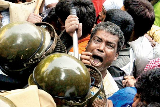 Police cane charging BJP workers during their proposed rally 