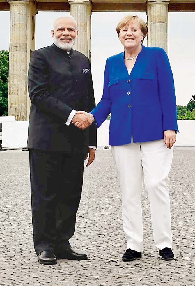 German Chancellor Angela Merkel with  Prime Minister Narendra Modi Pic/AFP