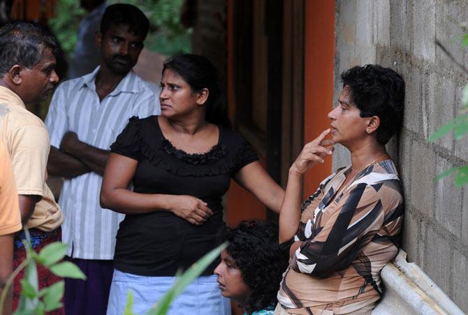 Relatives of landslide victims look on as military rescue workers and villagers search for survivors in Athweltota village in Kalutara. Pic/AFP