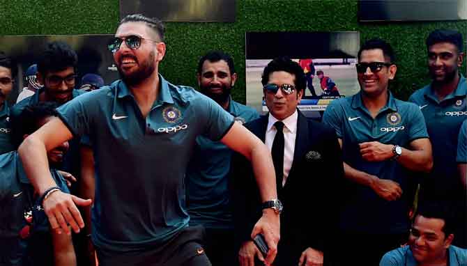 Yuvraj Singh breaks into a jig as master blaster Sachin Tendulkar and the Indian cricket team looks on at the screening of film 