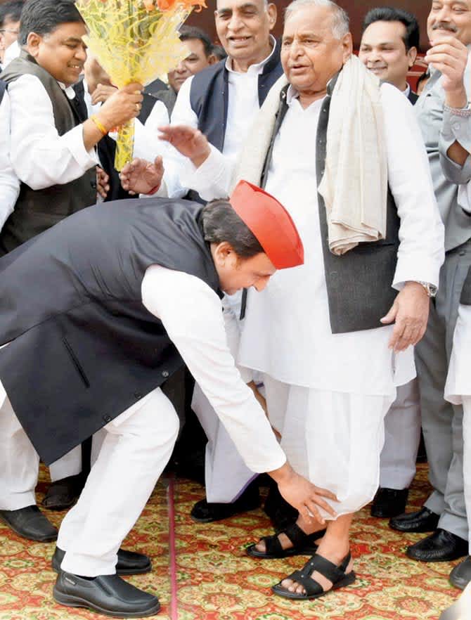 SP president Akhilesh Yadav seeks blessings of his father  Mulayam Singh Yadav during  his 79th birthday celebrations. PIC/PTI