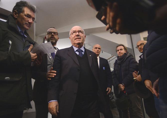 Italian Football Federation (FIGC) Carlo Tavecchio (C) arrives to speak to journalists outside the Italian Football Federation (FIGC) headquarters on November 15 2017, in Rome. Gian Piero Ventura was sacked as Italy coach today after the four-time champions failed to reach the World Cup finals. The veteran coach