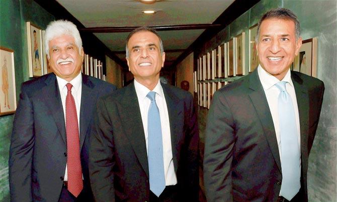 Bharti Enterprises founder and chairman Sunil Mittal with Vice Chairman Rajan Bharti Mittal and Rakesh Bharti Mittal after the announcement in New Delhi. Pic/PTI