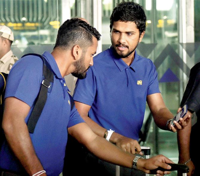 SL captain Dinesh Chandimal (right) chats with a teammate on arrival in Kolkata on Wednesday. Pic/PTI