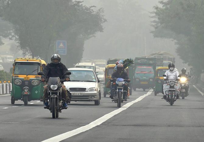 People commute during the foggy in New Delhi on Saturday.Pic/PTI