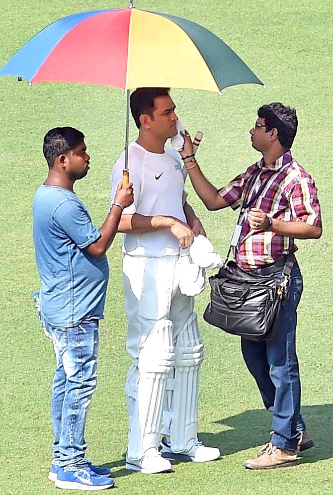 Cricketer MS Dhoni gets make-up for a shooting, at Eden Garden in Kolkata on Thursday. Pic/PTI