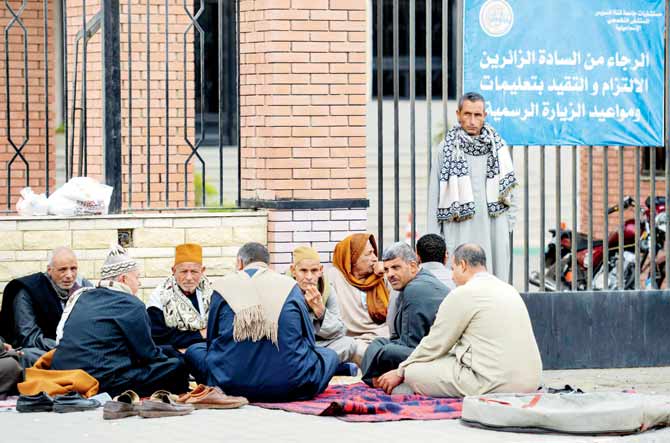 Relatives of the Sinai mosque terror attack victims (right) sit outside the Suez Canal University hospital in Ismailia on Saturday. pics/afp