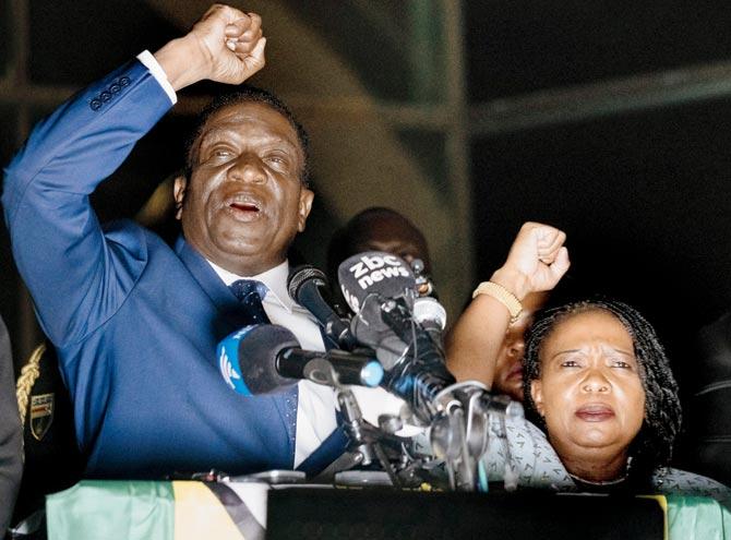 Emmerson Mnangagwa speaks to supporters flanked by his wife Auxilia at Zanu-PF party headquarters in Harare. Pic/AFP