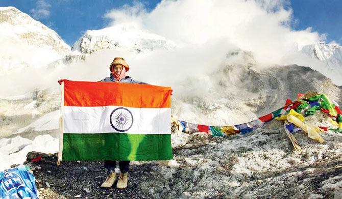 Shreerang, 6, proudly holds the Indian flag after reaching the Everest Base Camp