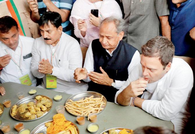 Rahul Gandhi (R)âu00c2u0080u00c2u0088along with Congress Gujarat poll in-charge Ashok Gehlot and GPCC chief Bharatsinh Solanki (L) having breakfast at Chandrala village in Gandhinagar, Gujarat, on Saturday. Pic/PTI