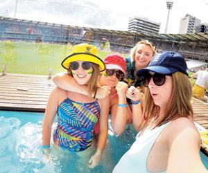 Ashes: Young Australian women cool off in the pool during Gabba Test