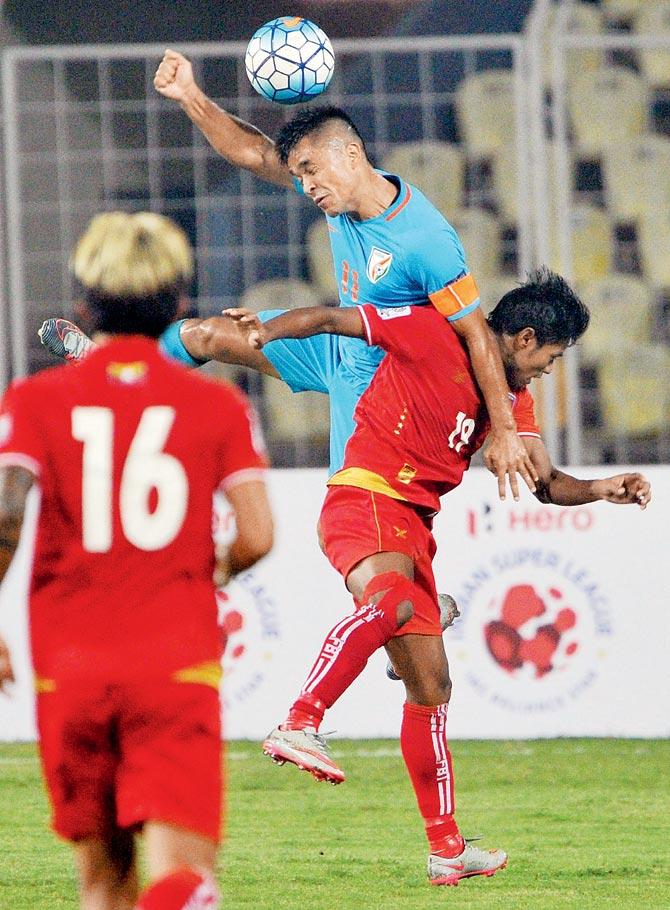 India skipper Sunil Chhetri (in blue) heads the ball during the AFC Asian Cup Qualifier at Nehru Stadium in Goa yesterday. Pic/PTI