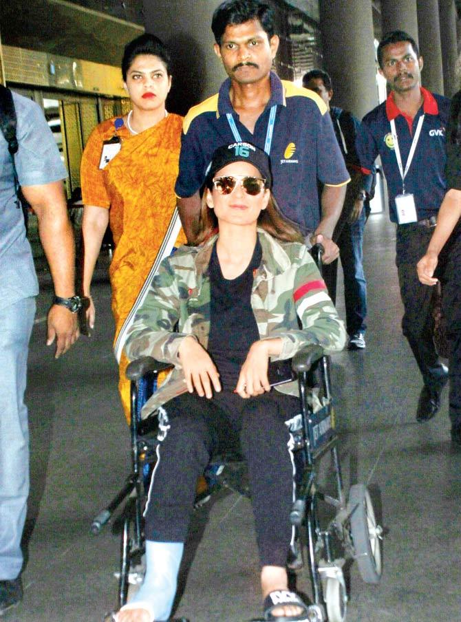 Injured Kangana Ranaut escorted on a wheelchair at the Mumbai airport. Pic/Yogen Shah