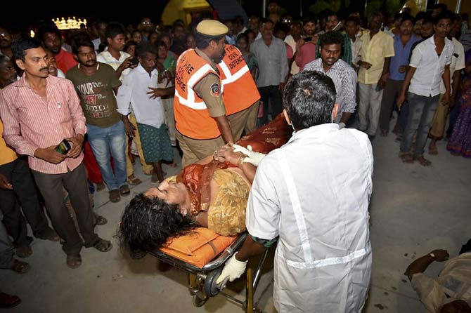 An injured being taken to hospital after an overloaded boat carrying 38 people capsized in the Krishna river near Vijayawada. Pic/AFP