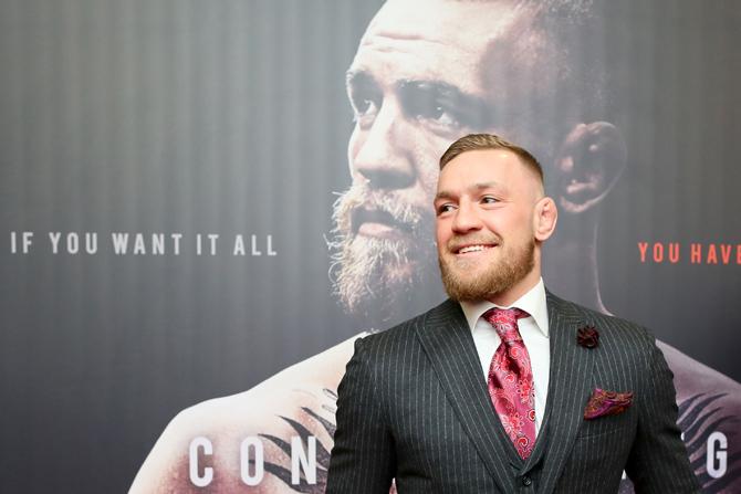 Irish mixed martial arts star Conor McGregor poses upon arrival to attend the world premiere of the documentary film 