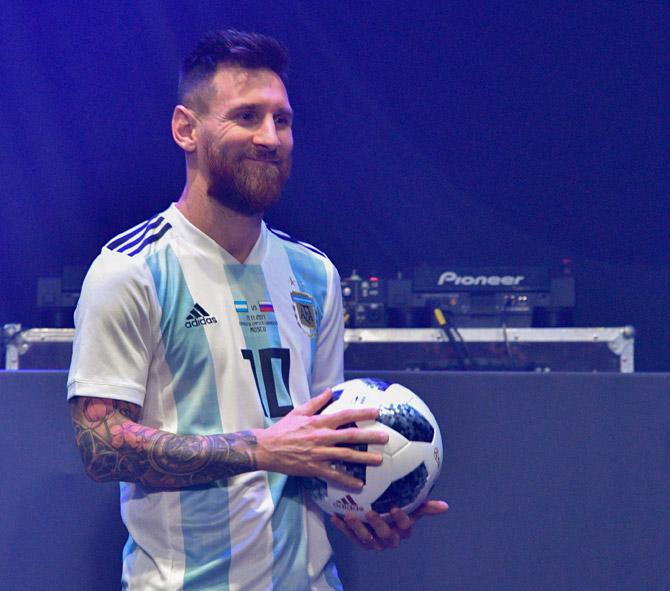 Barcelona and Argentina forward Lionel Messi poses with the official match ball for the 2018 World Cup football tournament, named "Telstar 18", during its unveiling ceremony in Moscow on November 9, 2017. Pic/AFP