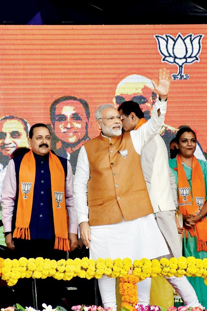 Prime Minister Narendra Modi waves at the crowd during the Gujarat Vikas Rally for the assembly elections in Surat. PIC/PTI