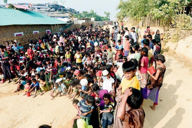Rohingya refugee children wait for food at a distribution centre in Ukhia district on Thursday. Pic/AFP