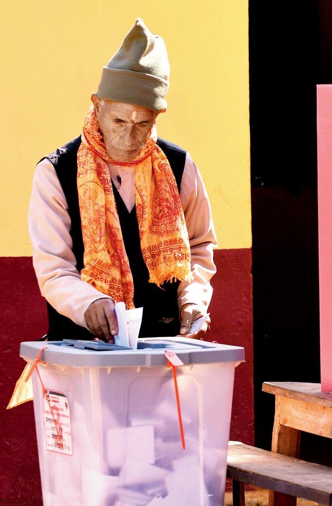 A Nepali voter casts his vote at  a polling station in Chautara. pic/afp