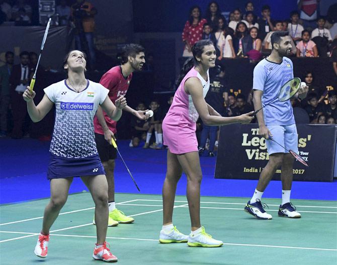 Indian badminton players Siana Nehwal, P V Sindhu, HS Prannoy, Srikanth Kidambi warm up with school children during an exhibition match being played at the Badminton Legends Vision World Tour Mumbai leg on Saturday evening. Pic/PTI