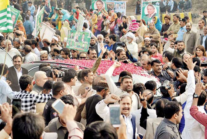Supporters of ousted Prime Minister Nawaz Sharif shout slogans as he leaves an accountability court in Islamabad on Friday. Pic/AP/PTI