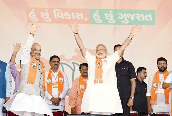 PM Narendra Modi and BJP chief Amit Shah wave confidently to supporters at an election rally on the outskirts of Ahmedabad last month. Pic/AFP