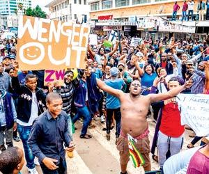 People stage protest to push Zimbabwe President Robert Mugabe to quit