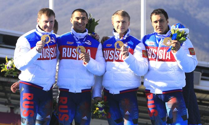 This file photo taken on February 23, 2014 shows (From L) Gold Medallists, Russia-1 four-man bobsleigh, pilot Alexander Zubkov, pushman Aleksei Negodaylo, pushman Dmitry Trunenkov and brakeman Alexey Voevoda celebrating at the Bobsleigh Four-man Medal Ceremony at the Sanki Sliding Center during the Sochi Winter Olympics. Two more Russian bobsleighers from the Russian-hosted 2014 Sochi Winter Olympics, Trunenkov and Negodaylo, have been stripped of their gold medals for doping, the International Olympic Committee (IOC) said on November 27, 2017. Pic/AFP