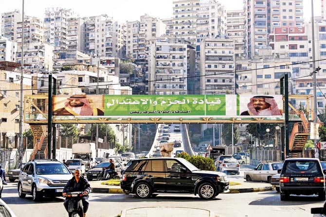 A poster of Saudi King Salman bin Abdulaziz and Crown Prince Mohammed bin Salman hangs on a pedestrian crossing bridge in the northern Lebanese port city of Tripoli. The caption reads ‘firm and moderating leadership’, days after Lebanese PM Saad Hariri announced his resignation. Pic/AFP