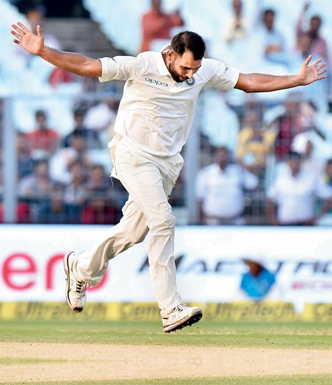 India pacer Mohd Shami celebrates the dismissal of Sri Lankan captain Dinesh Chandimal yesterday. He claimed six wickets in the Test, his first in India after the home series against England last year. Pics/PTI