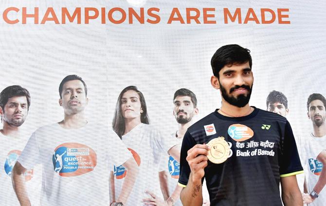 Badminton players Kidambi Srikanth shows his medal that was presented to him after he won Denmark Open Premier Super Series title, at a press conference in Hyderabad on Tuesday. Pic/PTI