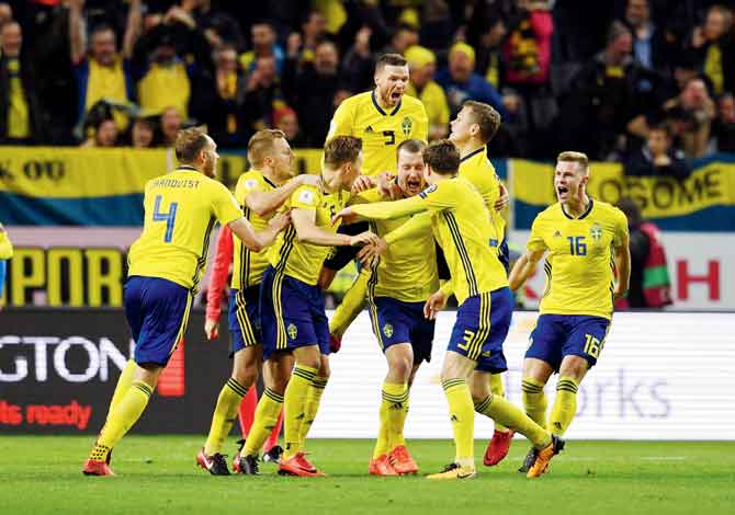 Swedish players celebrate their opening goal during the FIFA 2018 World Cup Qualifier playoff first leg against Italy at Friends Arena in Solna, Sweden on Saturday. Pic/Getty Images