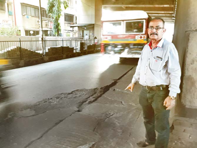 Prakashc Gidwani, 64, points at the accident spot under the Versova Metro bridge