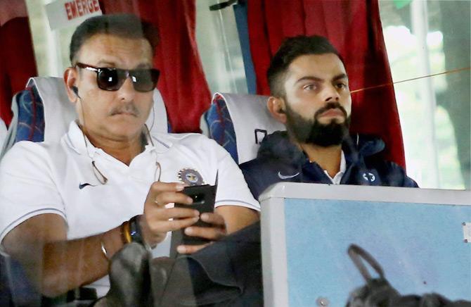Indian cricket captain Virat Kohli and coach Ravi Shastri on their arrival at the airport in Nagpur on Tuesday ahead of the second cricket test match against Sri Lanka. Pic/PTI