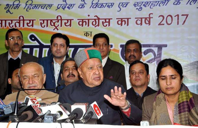 Himachal Pradesh chief minister Virbhadra Singh (C) talking with the media after releasing a party manifesto at the Indian National Congress Party office in Shimla. Pic/AFP