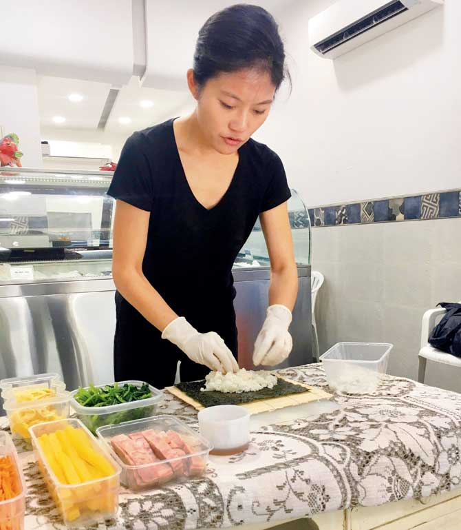 Yeoita Lee makes gimbap, a Korean-style rice-and-seaweed roll