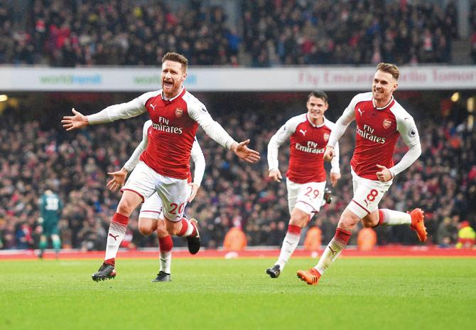 Arsenal’s Shkodran Mustafi (left) celebrates his goal with teammates against Tottenham during an EPL match on Saturday. Pic/Getty Images