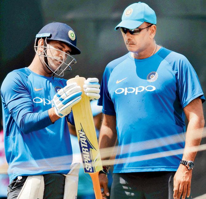 India coach Ravi Shastri (right) chats with MS Dhoni during a practice session at Pallekele Stadium in Kandy, Sri Lanka last August. Pic/PTI