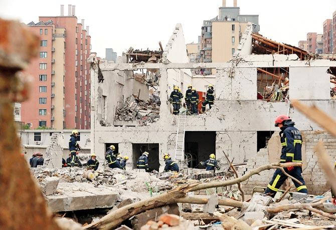 Rescue workers at the site of the explosion. pic/afp