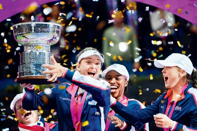 A jubilant US team pose with the Fed Cup after beating Belarus in the final at Minsk on Sunday. pic/AFP