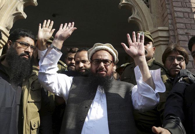 Hafiz Saeed, head of the Pakistani religious party, Jamaat-ud-Dawa, waves on his arrival to a court in Lahore, Pakistan. Pic/AFP