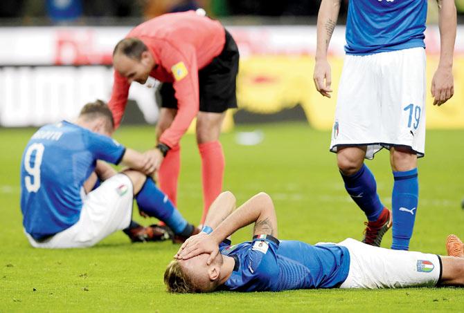 Dejected Italy players after their defeat on Monday night. Pic/AFP