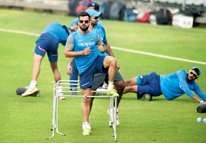 Virat Kohli (centre) warms up with teammates during a training session at the Wankhede stadium in Mumbai recently. Pic/AFP