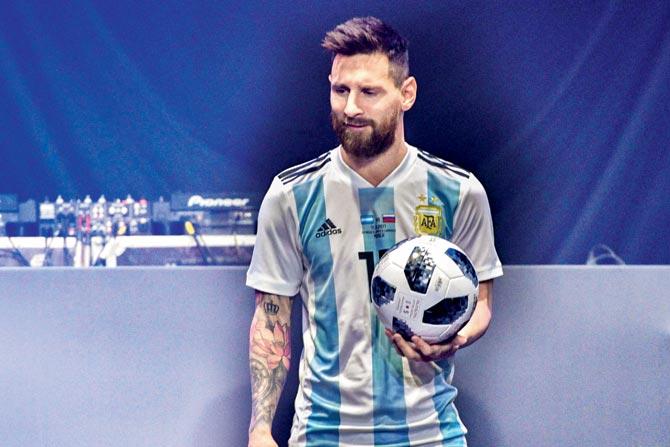 Argentine striker Lionel Messi poses with the official match ball for the 2018 World Cup — Telstar 18, at its unveiling in Moscow last night. Pic/ AFP